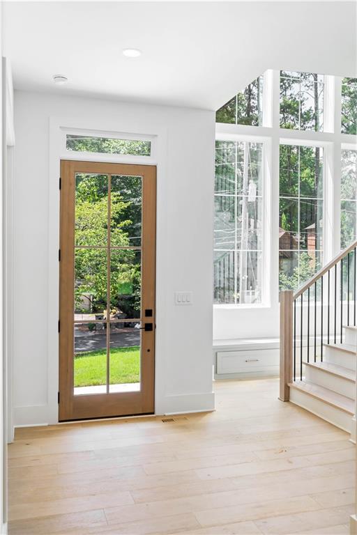 Upon entry, the flawless open layout captivates, showcasing European white oak hardwood floors, oversized windows, and designer light fixtures. The main level hosts a guest bedroom, a full bathroom, and a powder room, ensuring convenience and luxury.
