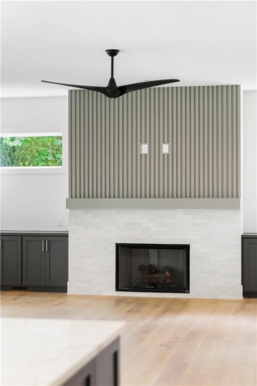 The expansive family room features custom built-ins, an inviting fireplace with a tile/wood accent surround, and western sliding doors leading to the covered outdoor lounge.