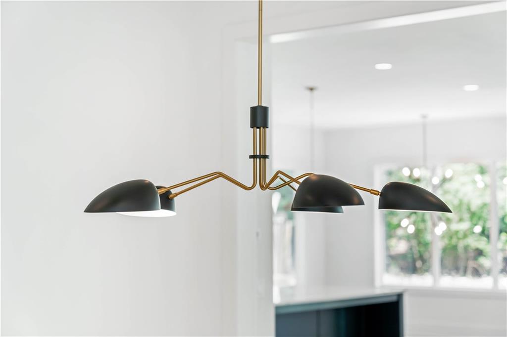 The main level hosts a guest bedroom, a full bathroom, and a powder room, ensuring convenience and luxury.