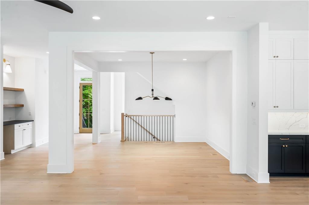 The main level hosts a guest bedroom, a full bathroom, and a powder room, ensuring convenience and luxury.
