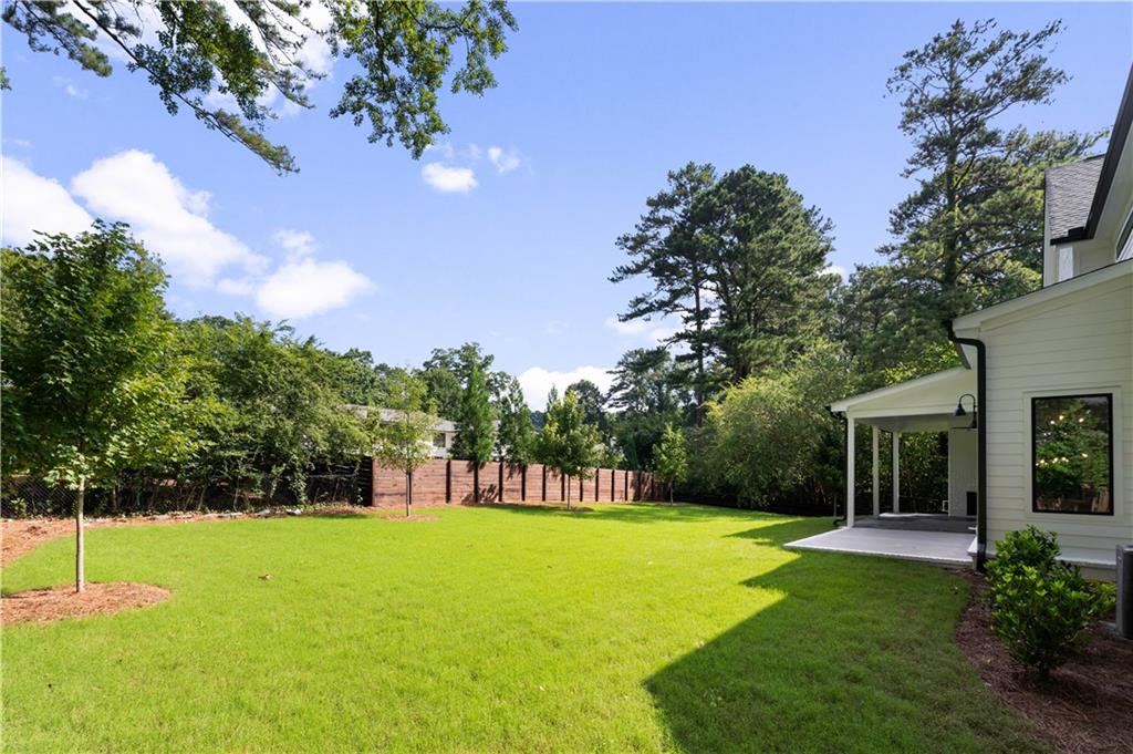 . Outside, the property offers a flat walk-out backyard, featuring a covered outdoor lounge with a fireplace and grilling patio—an ideal canvas for a future pool.