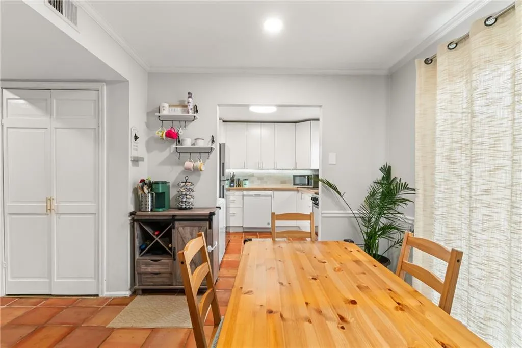 Dining space featuring visible vents and ornamental molding
