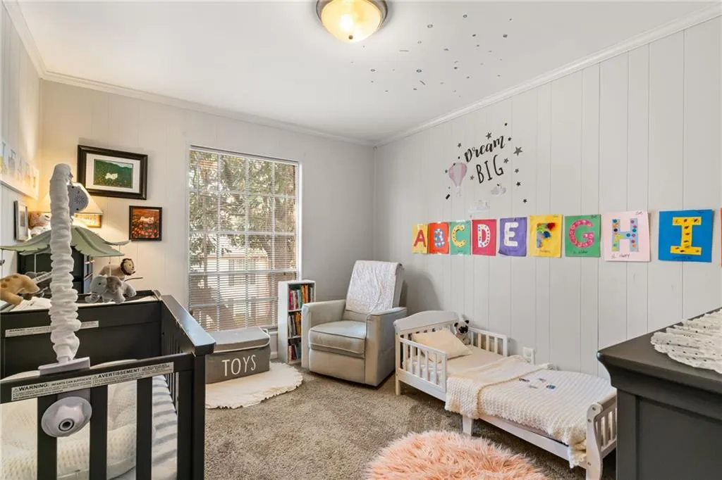 Bedroom with crown molding and carpet floors