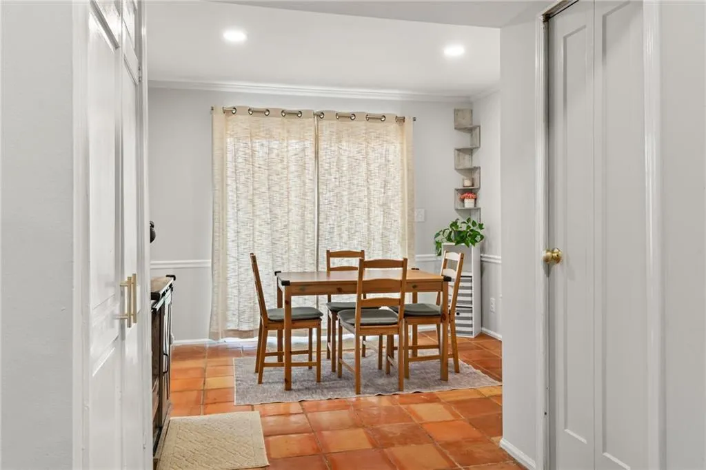 Dining area with recessed lighting and ornamental molding