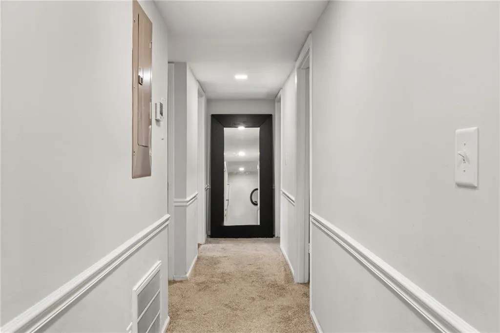 Corridor with light colored carpet