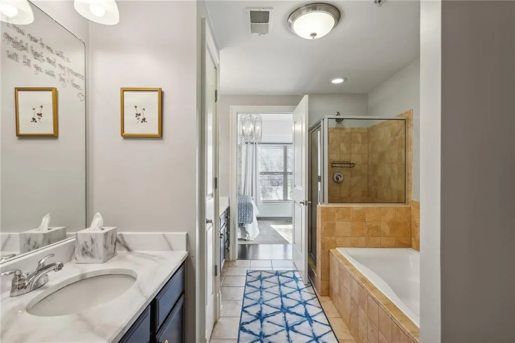 Primary bathroom with double vanities & separate shower / tub