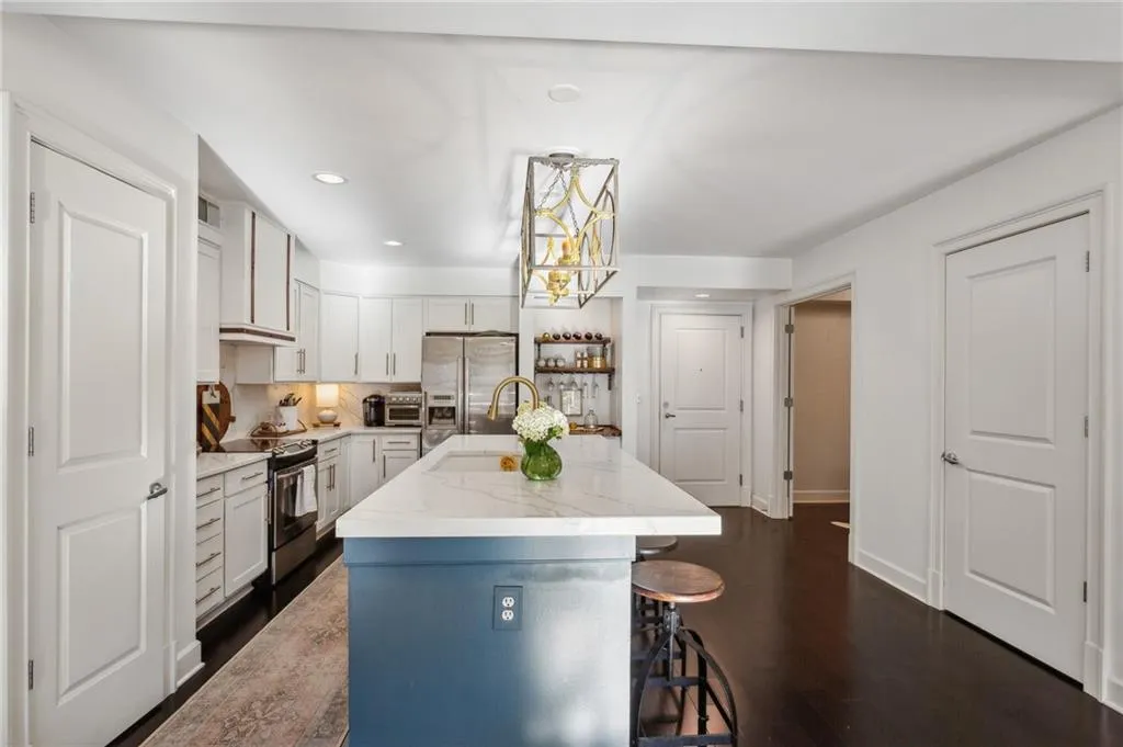 Kitchen featuring white cabinetry and stainless appliances