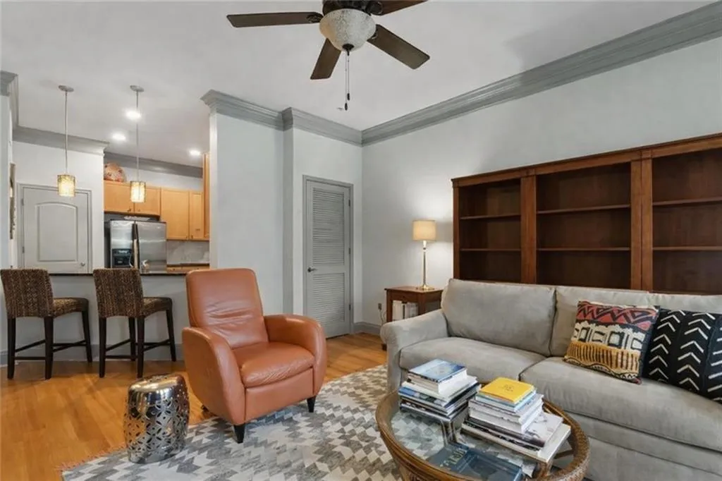 (virtually staged to remove excess) Living room featuring crown molding, a ceiling fan, light wood-style flooring, and recessed lighting