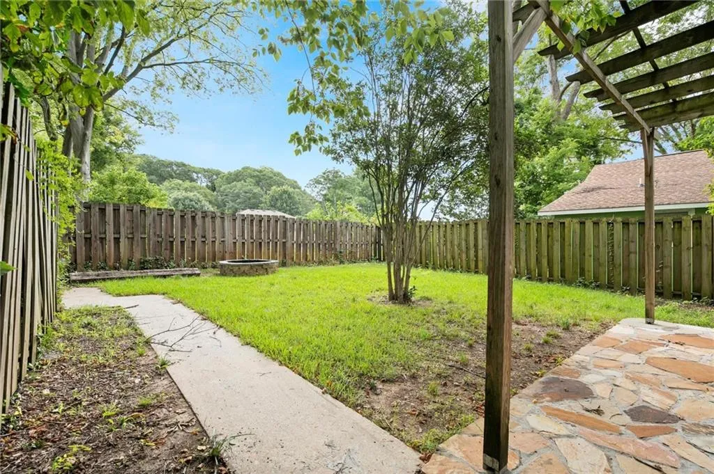 Fenced backyard featuring a patio
