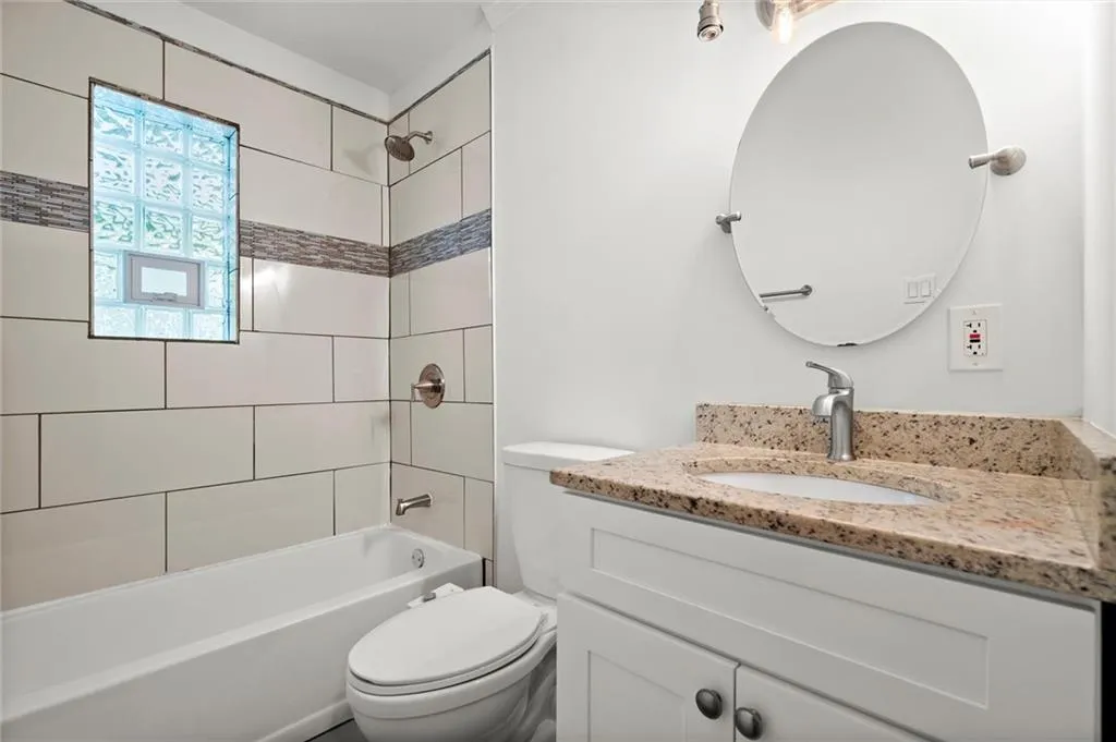 Bathroom with vanity and shower / bath combination
