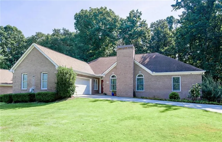 Brick exterior with a gabled roof and attached garage