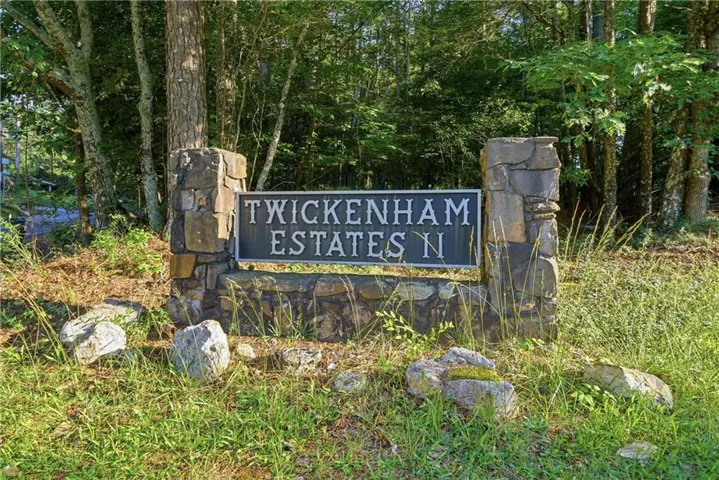 Stone-clad entry monument featuring a dark bronze-finish plaque