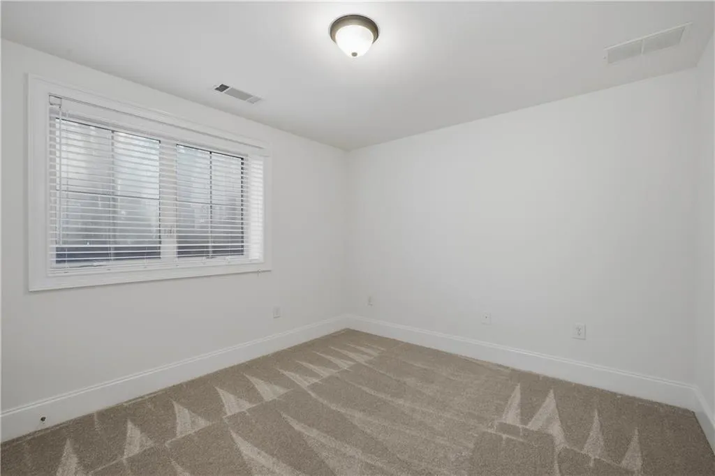 Spare room with baseboards and carpet flooring