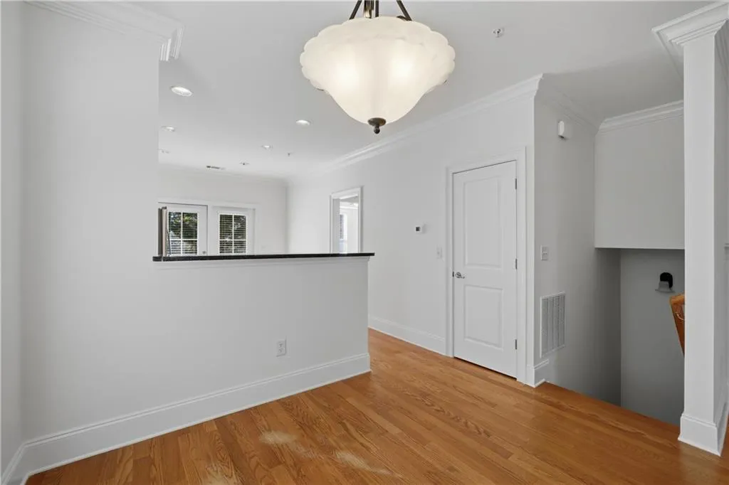 Unfurnished room featuring ornamental molding, wood finished floors, and recessed lighting