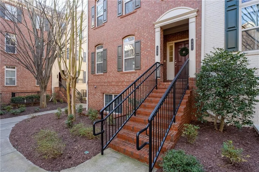 Entrance to property featuring brick siding
