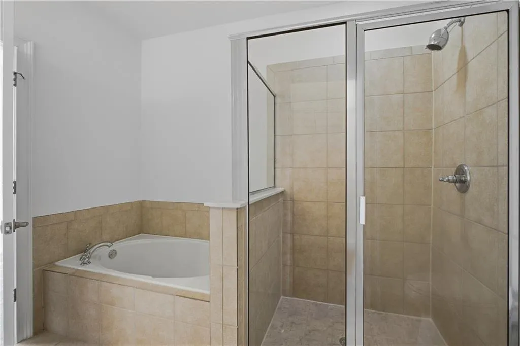 Bathroom featuring a garden tub and a stall shower