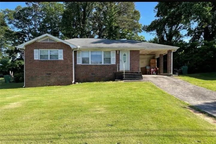 Brick exterior with white window shutters
