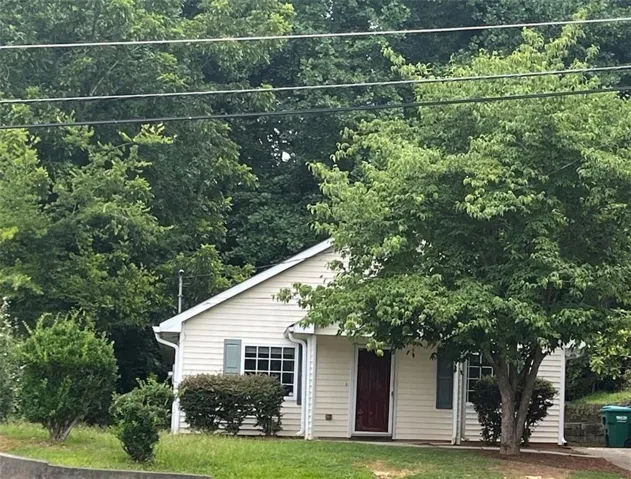 Light-colored siding exterior with a dark red front door