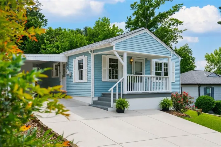 Blue siding exterior with white window shutters and trim