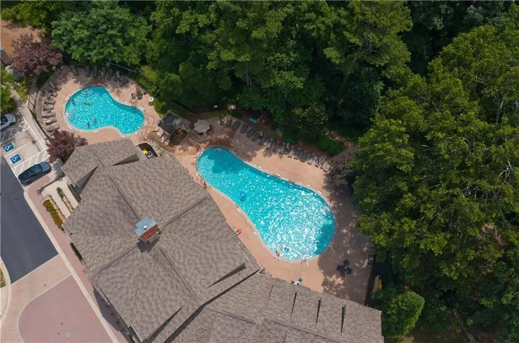 Community pool with a patio