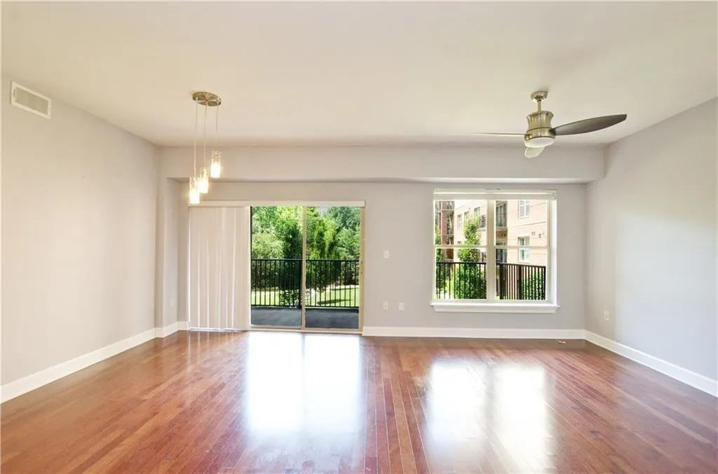 Unfurnished room with wood finished floors and a ceiling fan