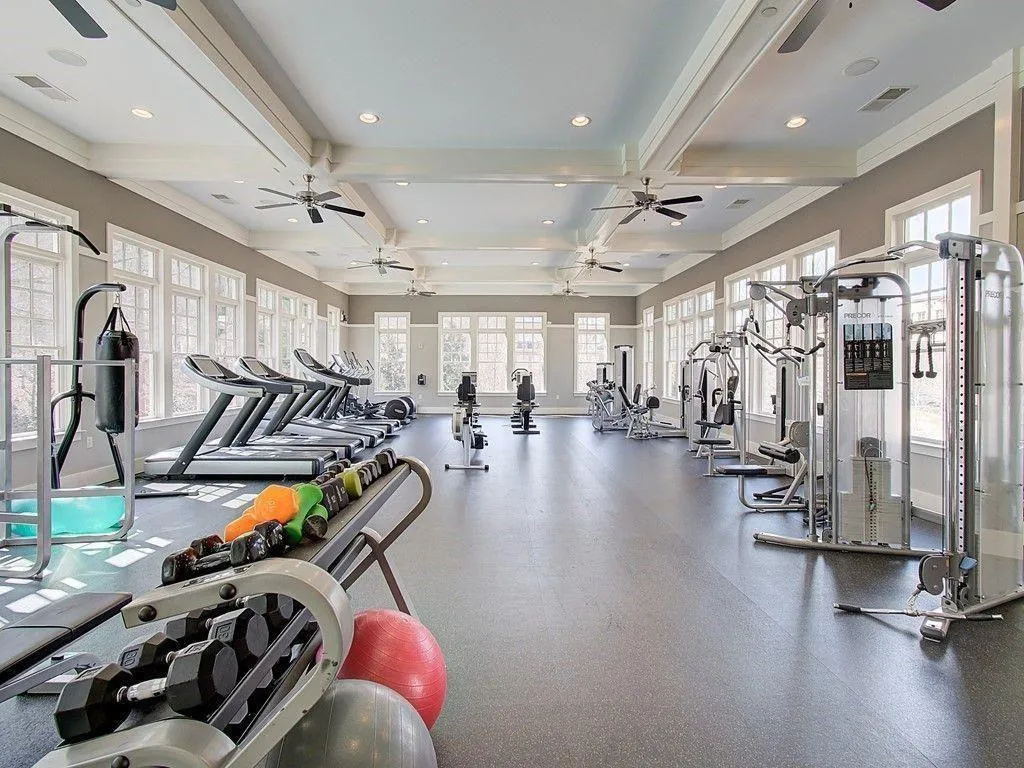 Workout area featuring beam ceiling, recessed lighting, coffered ceiling, and a ceiling fan