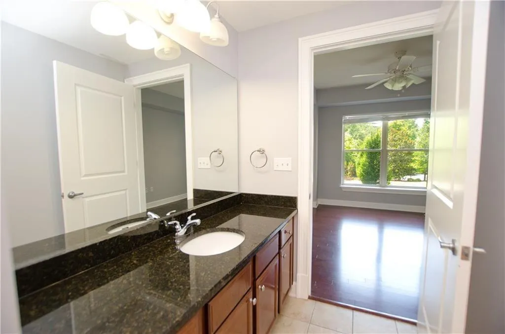 Bathroom featuring vanity, ceiling fan, and tile patterned floors
