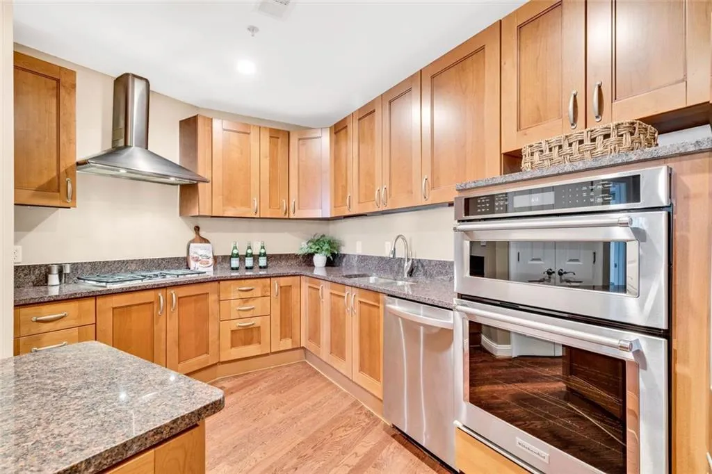 Functional and stylish kitchen with upscale finishes that includes stainless steel appliances, granite countertops and soft close cabinetry.