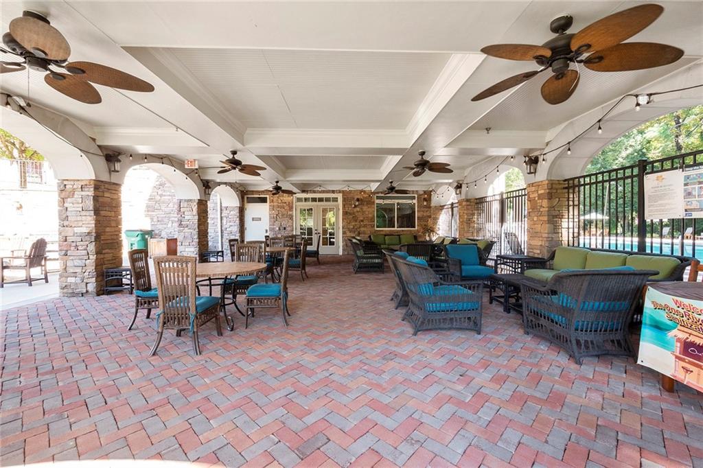 Adjacent to the pool area is this fabulous covered lanai area with tables, chairs and couches. It's the perfect spot to host your family and friends for the afternoon.