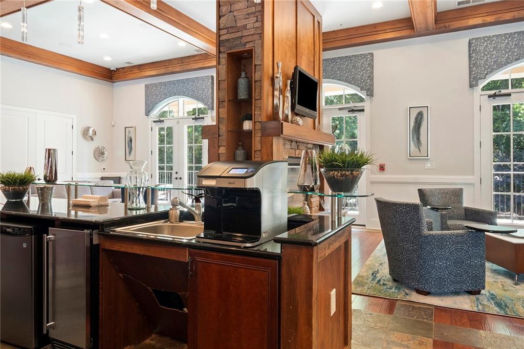 Main room of the Meeting House has a bar with a flavored water system, fridge, and ice maker.  Located just outside the gym so it's perfect to fill up your water bottle before working out!