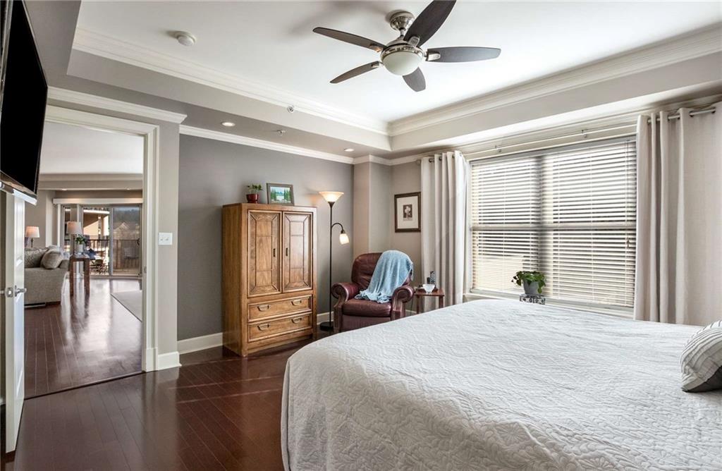 View of the primary bedroom looking back into the living spaces.  The custom lighting also continues here with extra can lights throughout the unit.