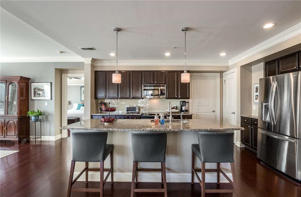 On demand hot water tap and stainless steel bottom drawer organizers make this kitchen very special and ready to please any chef!  Easily seat 3 or 4 people at the bar!