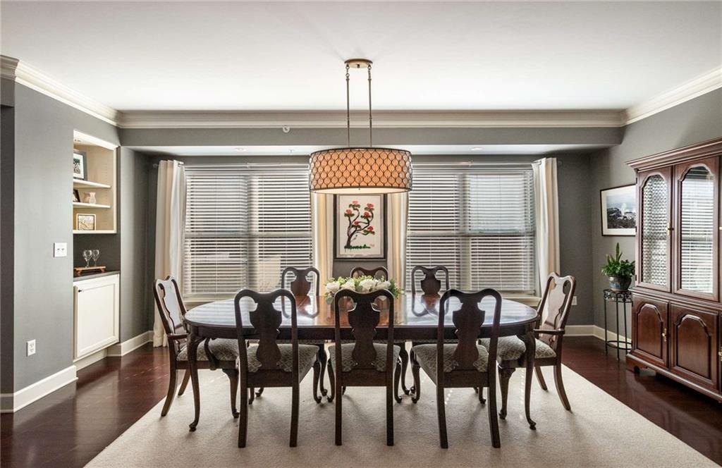 Dining area overlooks the wooded area.  Newer drum chandelier really showcases how large this space is and how many friends can fit comfortably with room to spare.