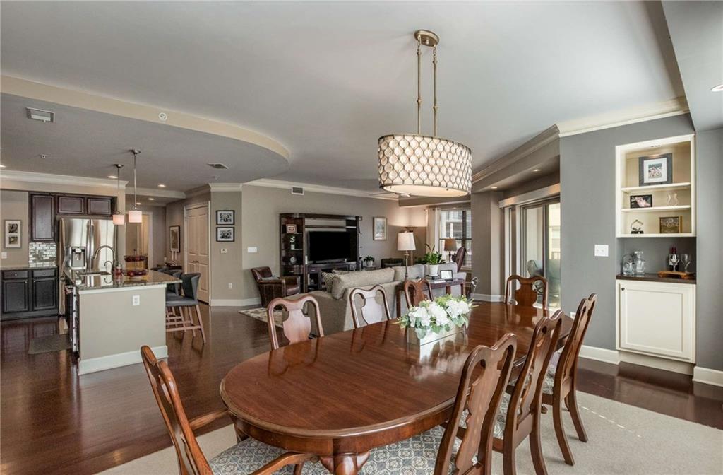 You never see a dining area this large in a condo. You can literally seat 12-14 people easily!  No need to sell your large dining room table if you are downsizing. Unit has 2 custom built in cabinets with granite countertop, glass shelves and lighting to display your art.  This could be a perfect spot for a small bar with extra storage.