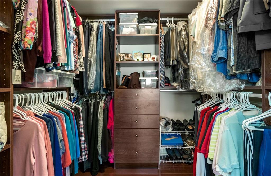 Say hello to closet organization!  Owners have installed a custom closet system including a bank of drawers, new wood floor and lighting.