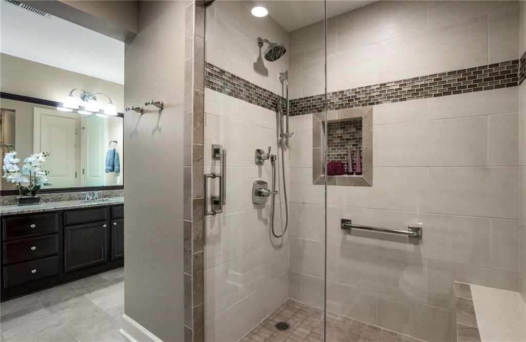 Spa like primary bathroom en suite has been completely renovated complete with a new, large walk in shower with seat, frameless glass door and niche for shampoos and soaps.
