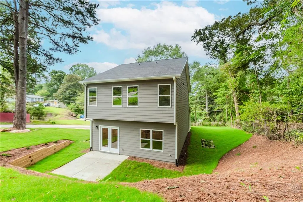Rear view of property featuring a yard and a patio area