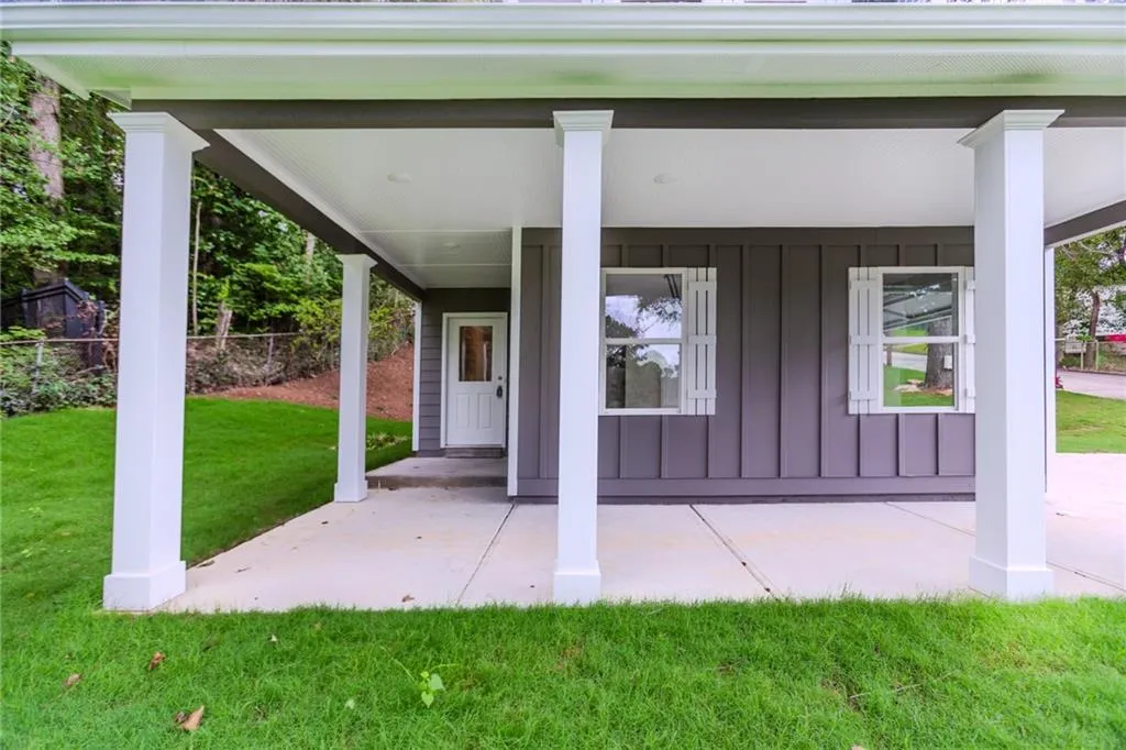 Entrance to property with board and batten siding and a porch