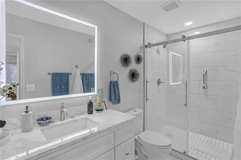 Full bathroom featuring vanity and a stall shower