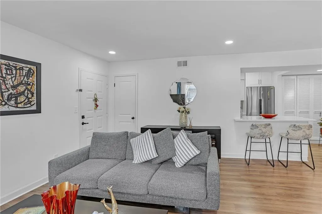 Living room with recessed lighting and light wood-type flooring