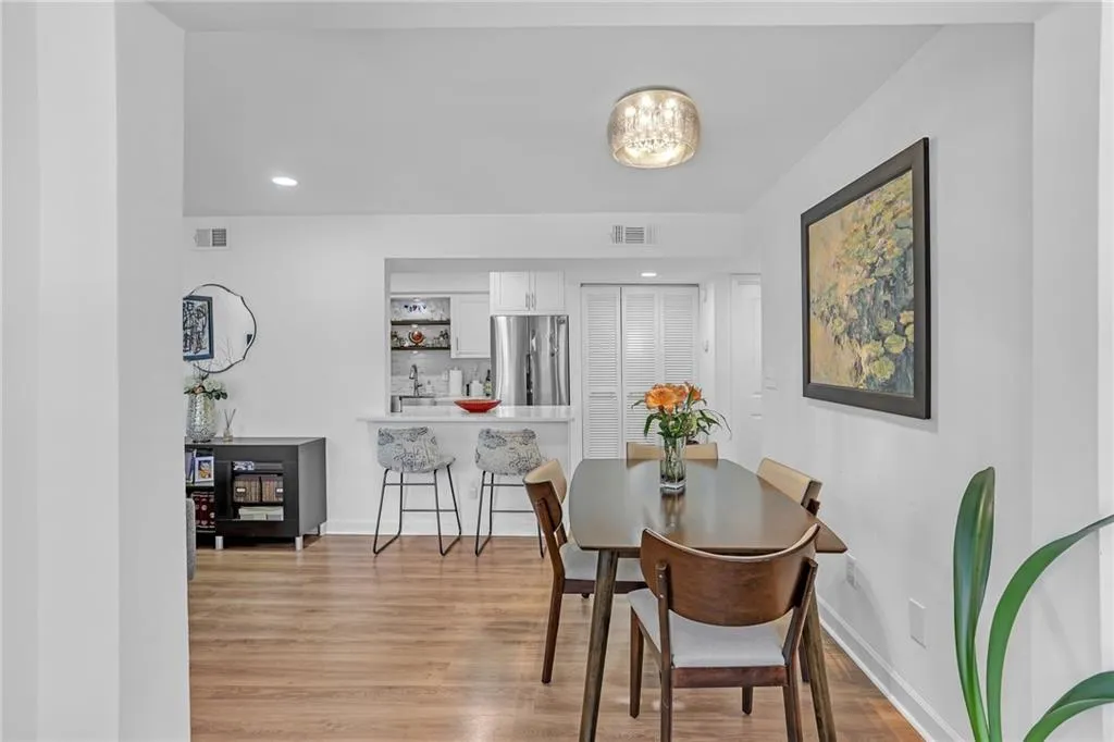 Dining area with recessed lighting and light wood-type flooring