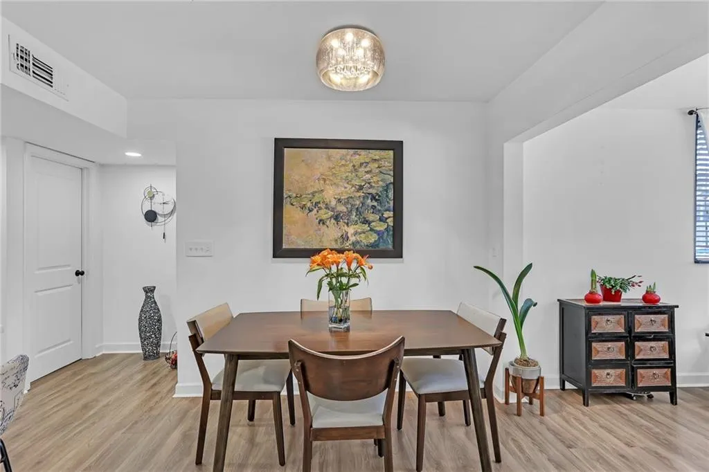 Dining room featuring light wood-type flooring and a chandelier