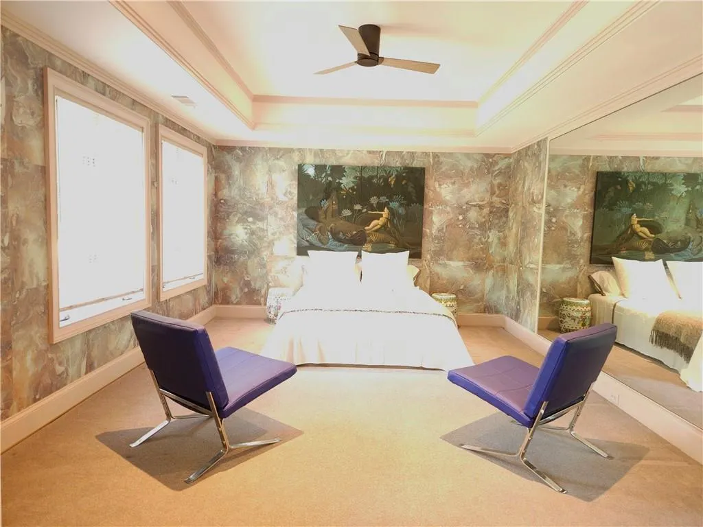 French doors lead into a large space that serves as the 4th bedroom
