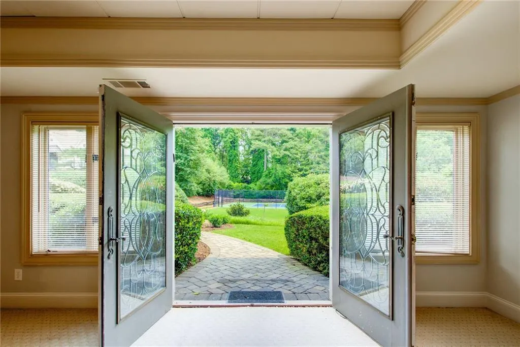 Double doors lead to garden path on side of home.