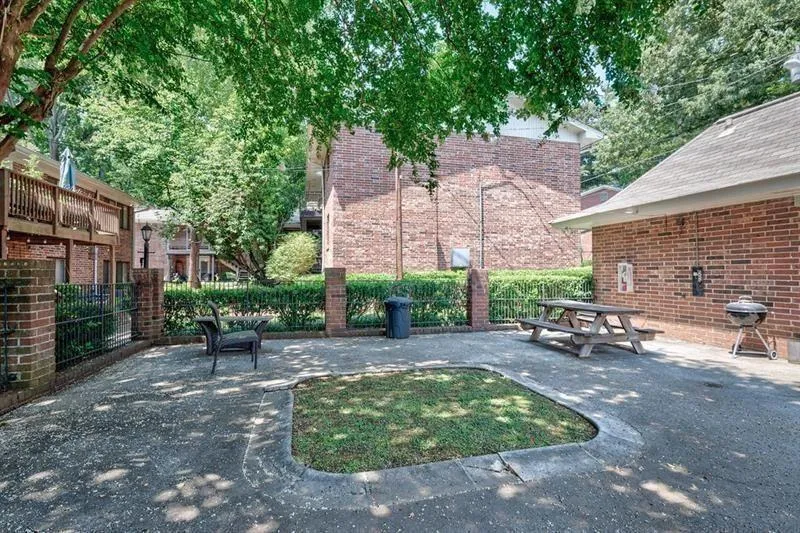 View of the pool patio area with tables and grills.