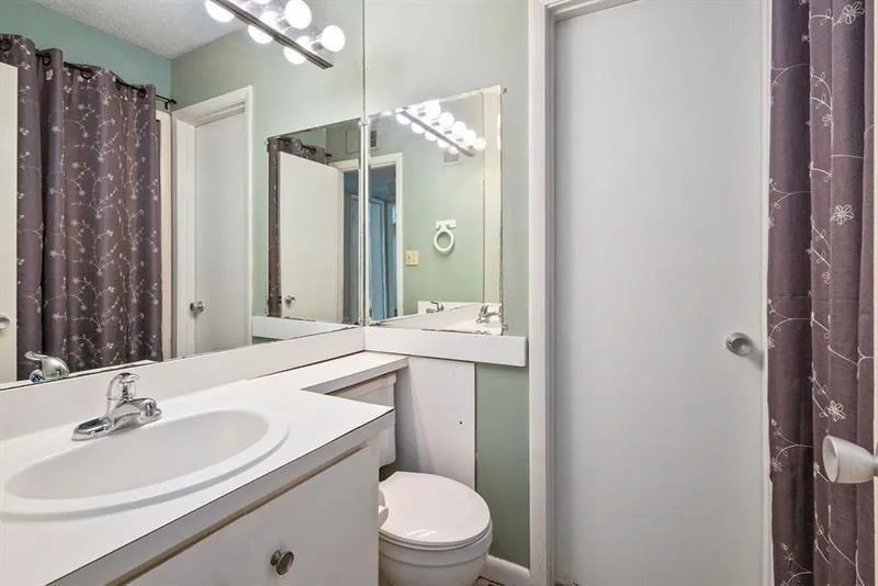 Half bath featuring vanity and located off the hallway.