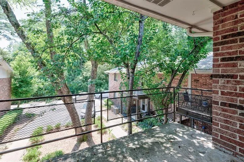 View from covered deck looking out to mature trees and shrubs.