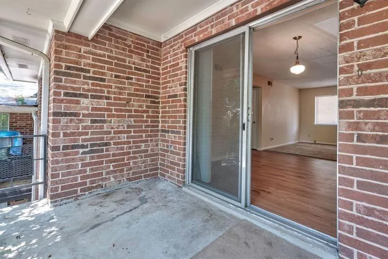 Covered balcony has ample room for nice seating arrangement.
