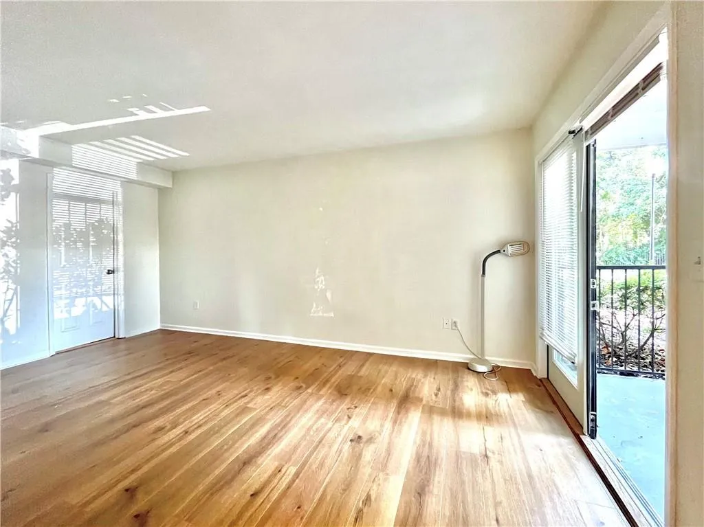 Spare room with light wood-style floors and baseboards
