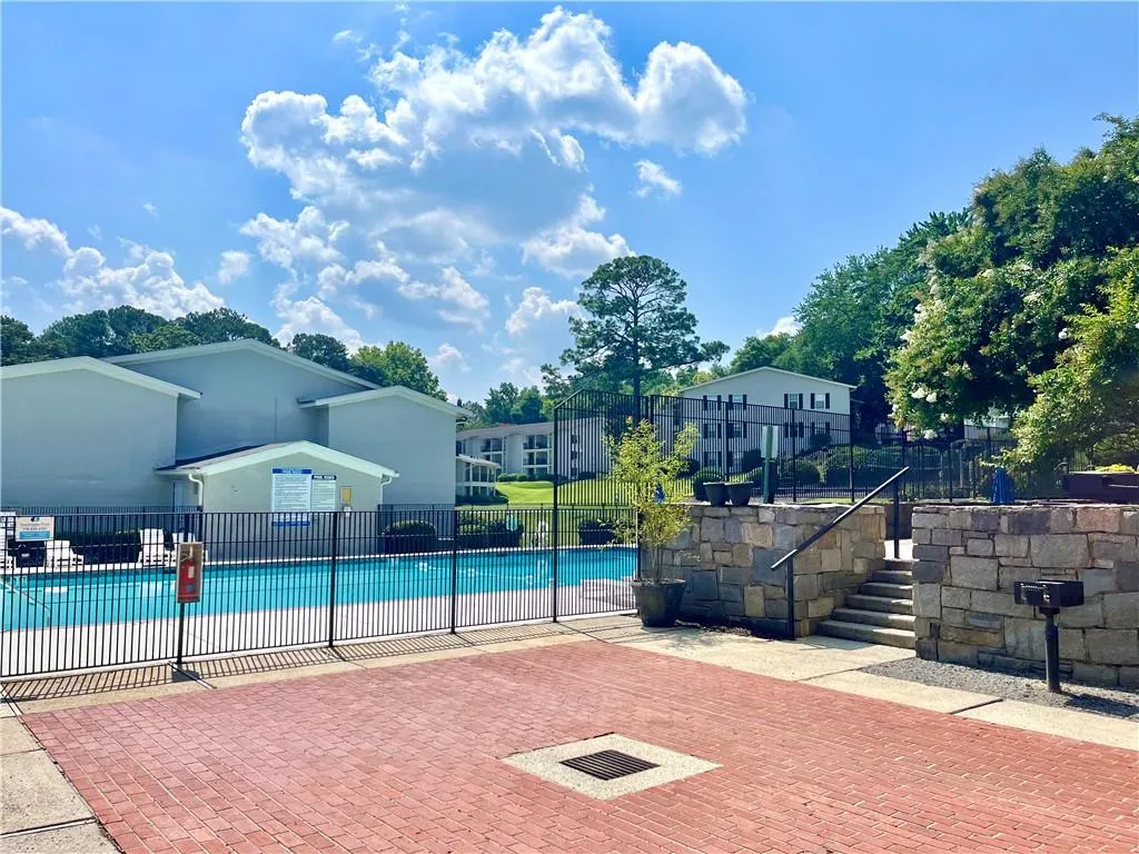 Community pool featuring a patio area and a residential view